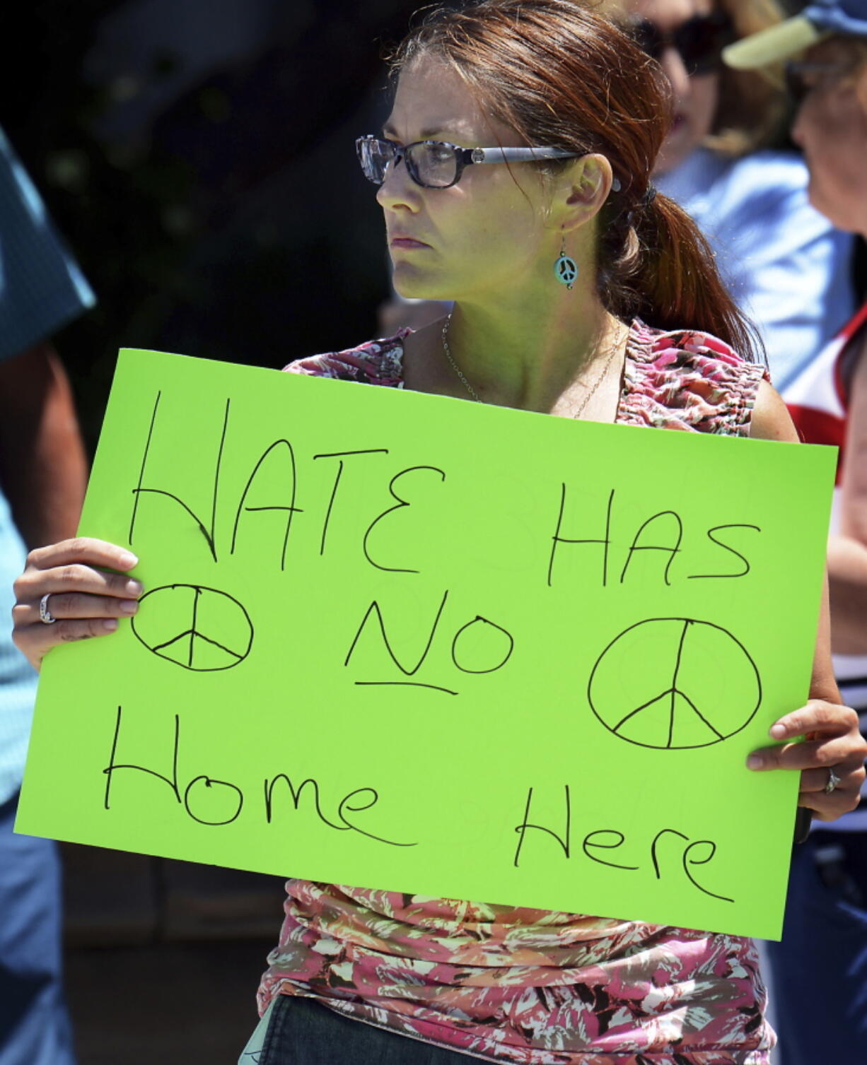 A woman holds a sign outside Lackawanna College on Friday in Scranton, Pa., where U.S. Attorney Jeff Sessions spoke on immigration policy and law enforcement actions.