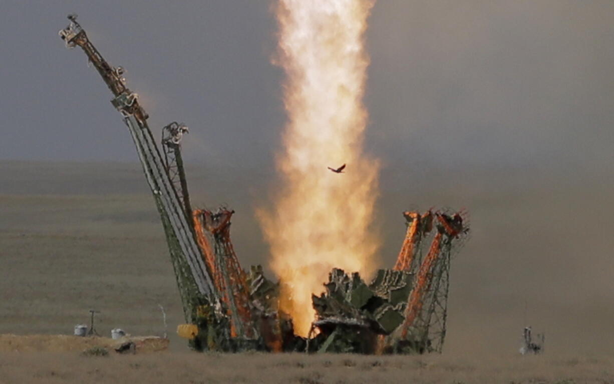 A bird flies in front of the trail of the Soyuz-FG rocket booster with Soyuz MS-09 space ship, carrying a new crew to the International Space Station, ISS, as it blasts off at the Russian leased Baikonur cosmodrome, Kazakhstan, on Wednesday. The Russian rocket carries U.S. astronaut Serena Aunon-Chancellor, Russian cosmonaut Sergey Prokopyev, and German astronaut Alexander Gerst.