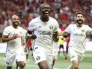 Portland Timbers defender Larrys Mabiala (33) celebrates a goal with forward Samuel Armenteros (99) and midfielder Diego Valeri (8) against Atlanta United in the first half of an MLS soccer match Sunday, June 24, 2018, in Atlanta, Ga.