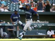 Seattle Mariners’ Dee Gordon scores a run on a single by Jean Segura in the 10th inning against the Baltimore Orioles, Thursday. Seattle won 4-2 in 10 innings.