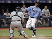 Seattle Mariners catcher Mike Zunino, left, tags out Tampa Bay Rays’ Johnny Field, right, as Field was trying to score on a single by Carlos Gomez during the ninth inning of a baseball game Sunday, June 10, 2018, in St. Petersburg, Fla.