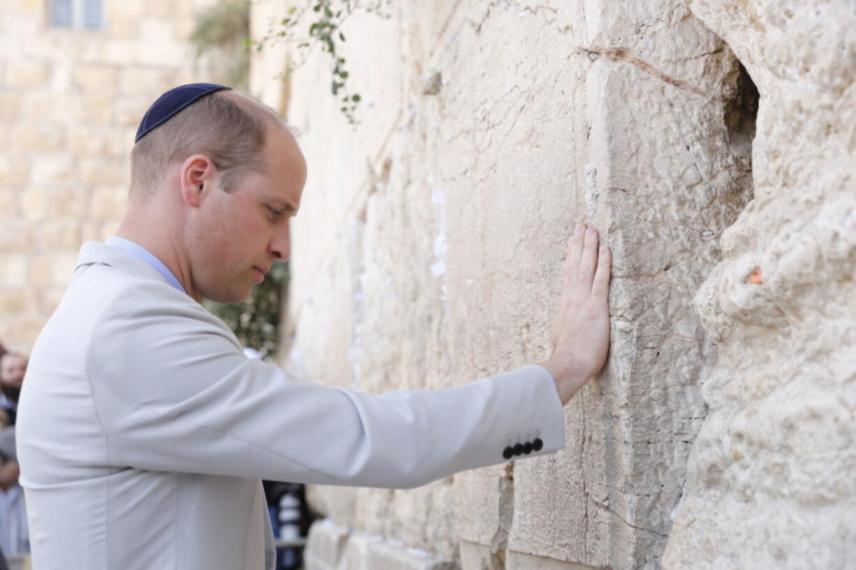 Britain’s Prince William touches the Western Wall on Thursday in the Old City of Jerusalem.