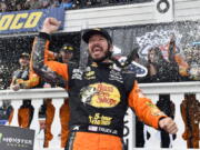 Martin Truex Jr. celebrates in Victory Lane after winning a NASCAR Cup Series auto race Sunday, June 3, 2018, in Long Pond, Pa.