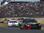 Martin Truex Jr. (78) leads Kevin Harvick (4) through a turn during a NASCAR Sprint Cup Series auto race Sunday, June 24, 2018, in Sonoma, Calif.