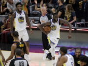 Golden State Warriors' Draymond Green (23) and Jordan Bell celebrate at the end of Game 4 of basketball's NBA Finals against the Cleveland Cavaliers, Friday, June 8, 2018, in Cleveland. The Warriors defeated the Cavaliers 108-85 and swept the series.