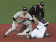 Oregon State shortstop Cadyn Grenier (2) tags out Minnesota’s Ben Mezzenga (1) during an NCAA college baseball tournament super regional game Saturday, June 9, in Corvallis, Ore.