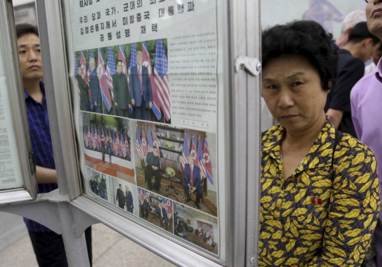 People read a newspaper dominated with news on the summit between U.S. President Donald Trump and North Korean leader Kim Jong Un at a subway station in Pyongyang, North Korea. North Koreans are getting a new look at U.S. President Donald Trump now that his summit with leader Kim Jong Un is safely over and it’s a far cry from the “dotard” label Pyongyang slapped on him last year.