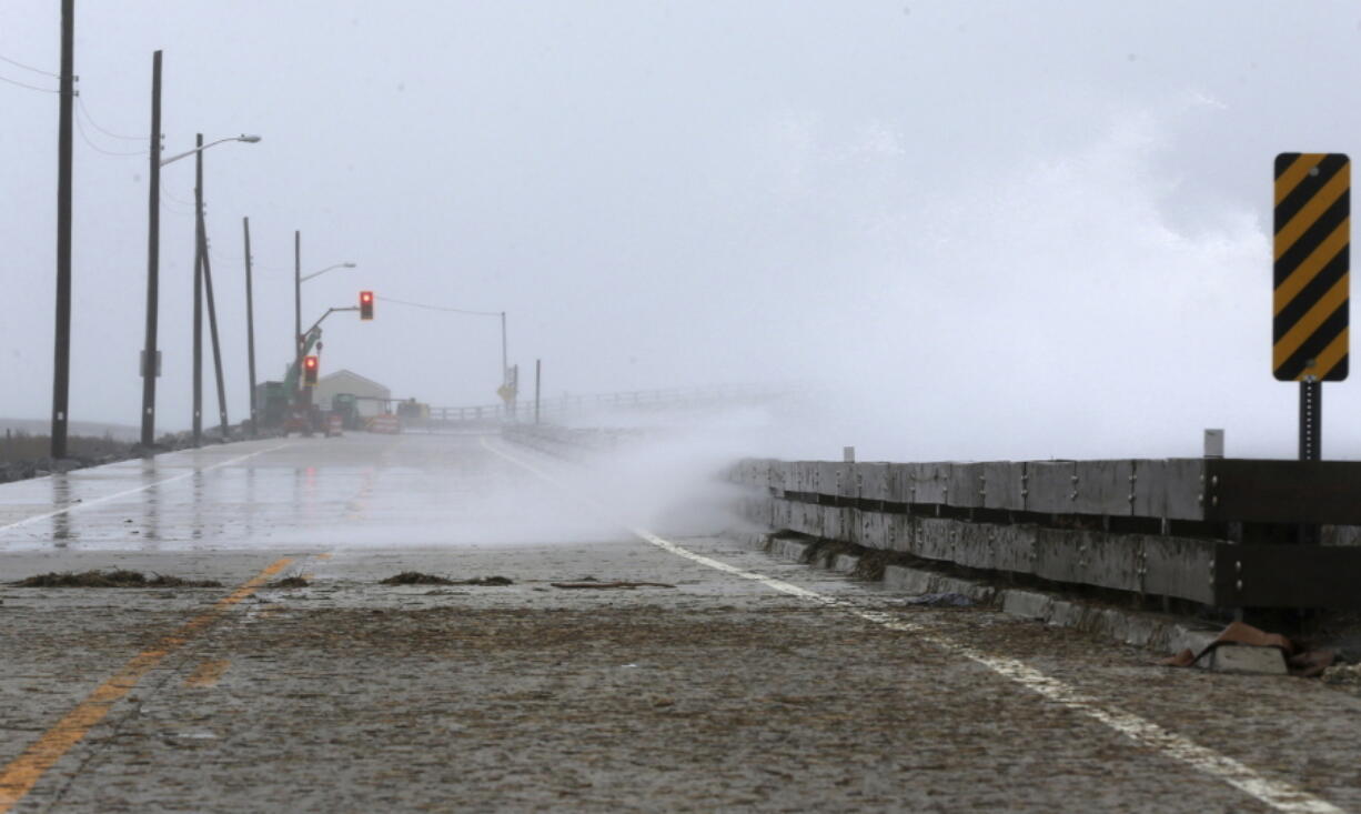 FILE - In this March 21, 2018 file photo, heavy surf crashes over the seawall at Townsends Inlet on Ocean Drive between Sea Isle City and Avalon, N.J. A new report finds that high-tide flooding is happening across the United States at twice the rate it was just 30 years ago, and predicts records for such flooding will continue to be broken for decades as sea levels rise. The National Oceanographic and Atmospheric Administration said high tide flooding, sometimes called sunny-day or “nuisance flooding,” tied or set records last year in more than a quarter of the 98 places the agency monitors around the country.