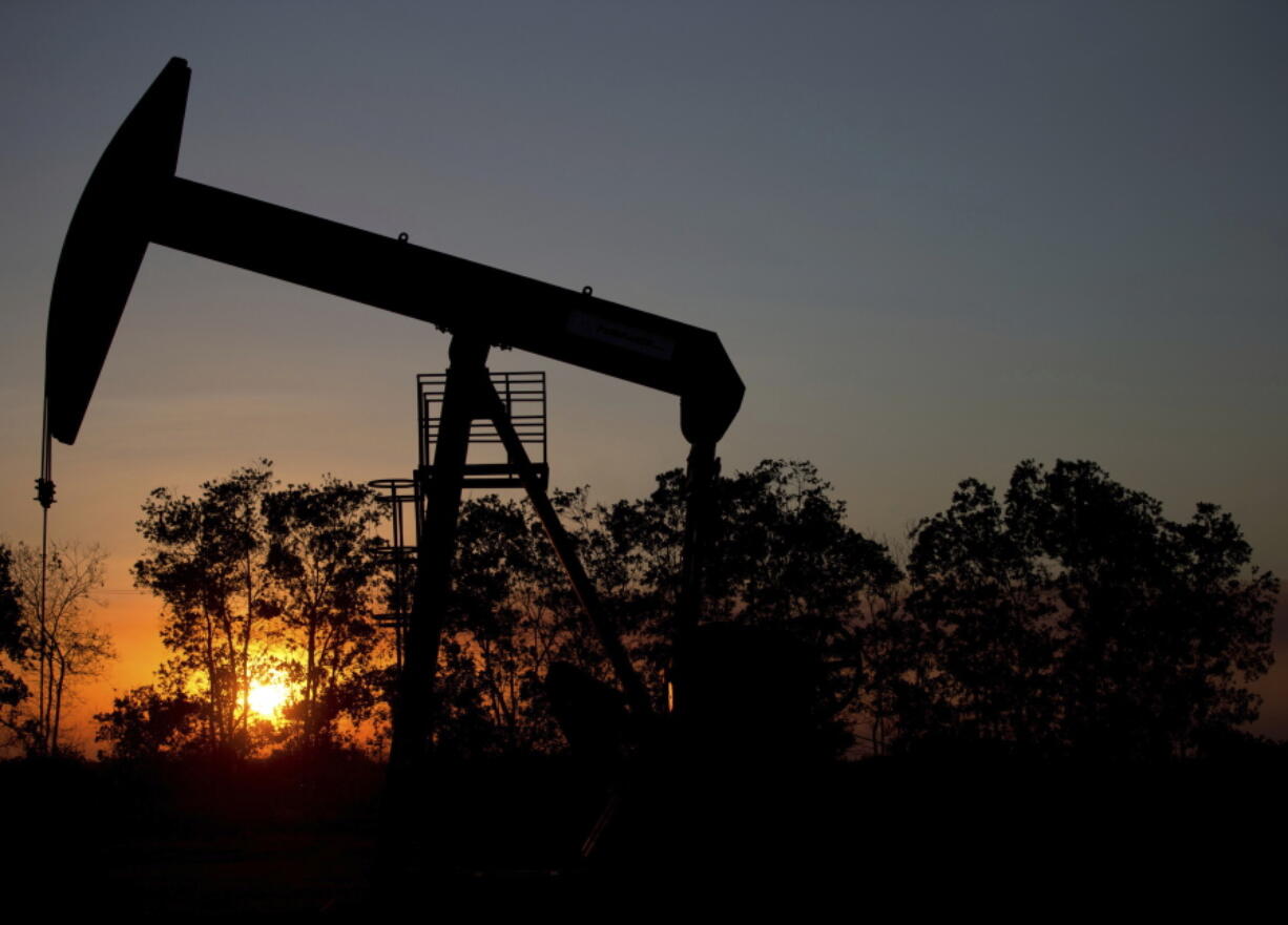 The sun sets behind an oil well in a field near El Tigre, Venezuela. Ministers from the Organization of the Petroleum Exporting Countries and non-OPEC nations led by Russia meet in Vienna on today and Saturday.