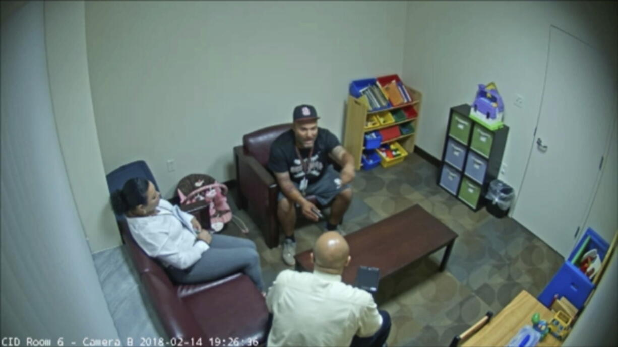 In this Feb. 14, 2018 frame from surveillance video provided by the Broward Sheriff’s Office, Andrew Medina, center, is interviewed by detectives following the shooting at Marjory Stoneman Douglas High School in Florida. Medina, a baseball coach and unarmed campus monitor, told detectives he watched Nikolas Cruz get out of an Uber and head straight to the building where 17 people would be killed moments later at the school.