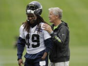 Seattle Seahawks head coach Pete Carroll, right, talks with linebacker Shaquem Griffin following NFL football practice, Thursday, June 14, 2018, in Renton, Wash. (AP Photo/Ted S.