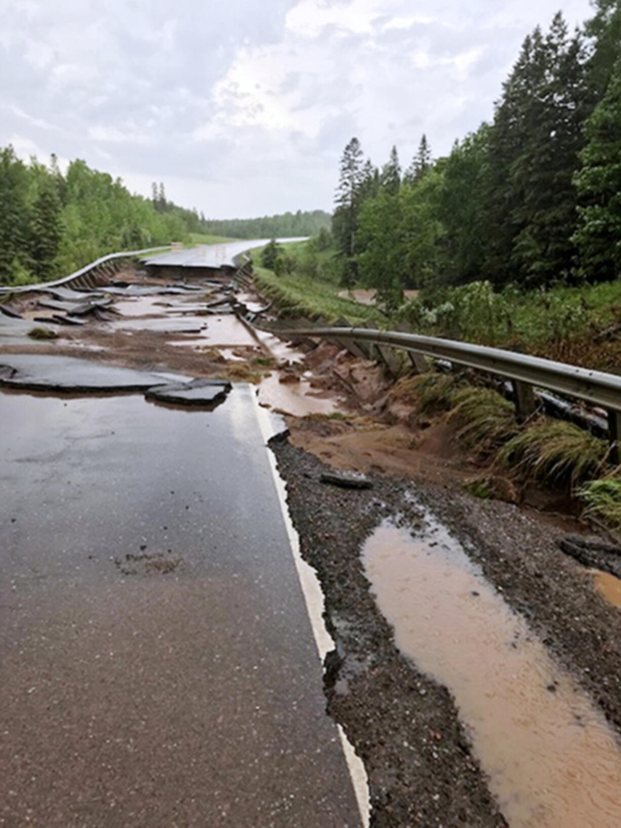 Minnesota Highway 23 damaged by flash flooding at the south fork Nemadji River crossing near Wrenshall, Minn. The National Weather Service has since extended a flood warning through Thursday for northwestern Wisconsin and neighboring areas in Minnesota.