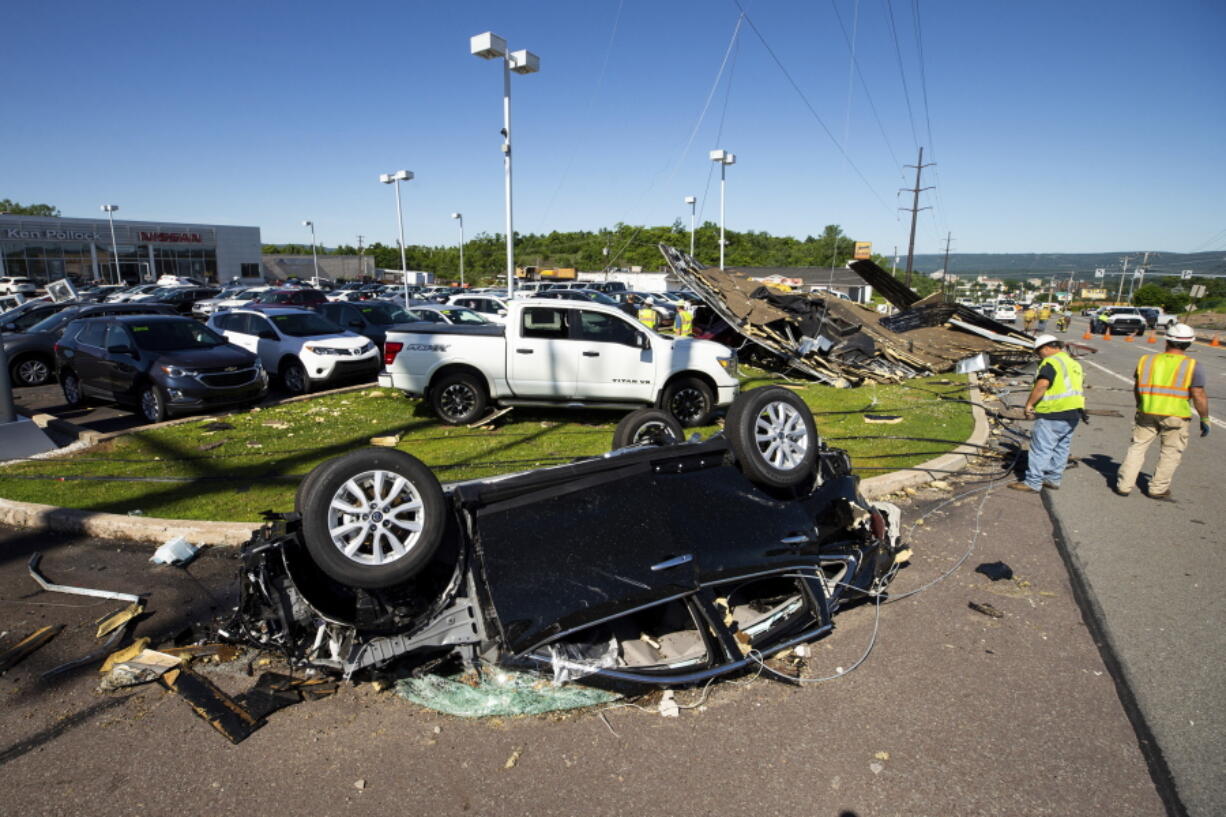 A Nissan sedan on the lot at Ken Pollock Nissan dealership in Wilkes-Barre Twp., Pa. is destroyed on Thursday, June 14, 2018 after a strong storm moved through the area on Wednesday night. A powerful storm has pounded parts of Pennsylvania, damaging buildings, overturning cars and downing trees and power lines.