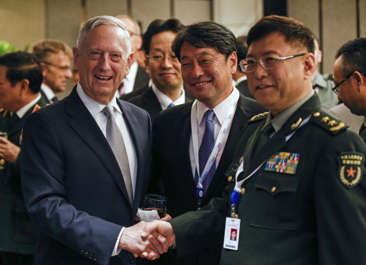 From left, U.S. Defense Secretary Jim Mattis, Japan’s Defense Minister Itsunori Onodera and China’s People’s Liberation Army’s Academy of Military Science Deputy President He Lei pose for photos at a ministerial roundtable on the sidelines of the 17th International Institute for Strategic Studies (IISS) Shangri-la Dialogue, an annual defense and security forum in Asia, in Singapore, Saturday, in Singapore.