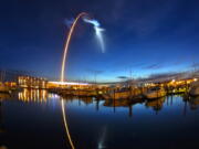 A SpaceX Falcon 9 rocket’s exhaust plume is illuminated during a launch just before dawn Friday at Launch Complex 40 at Cape Canaveral, Fla.