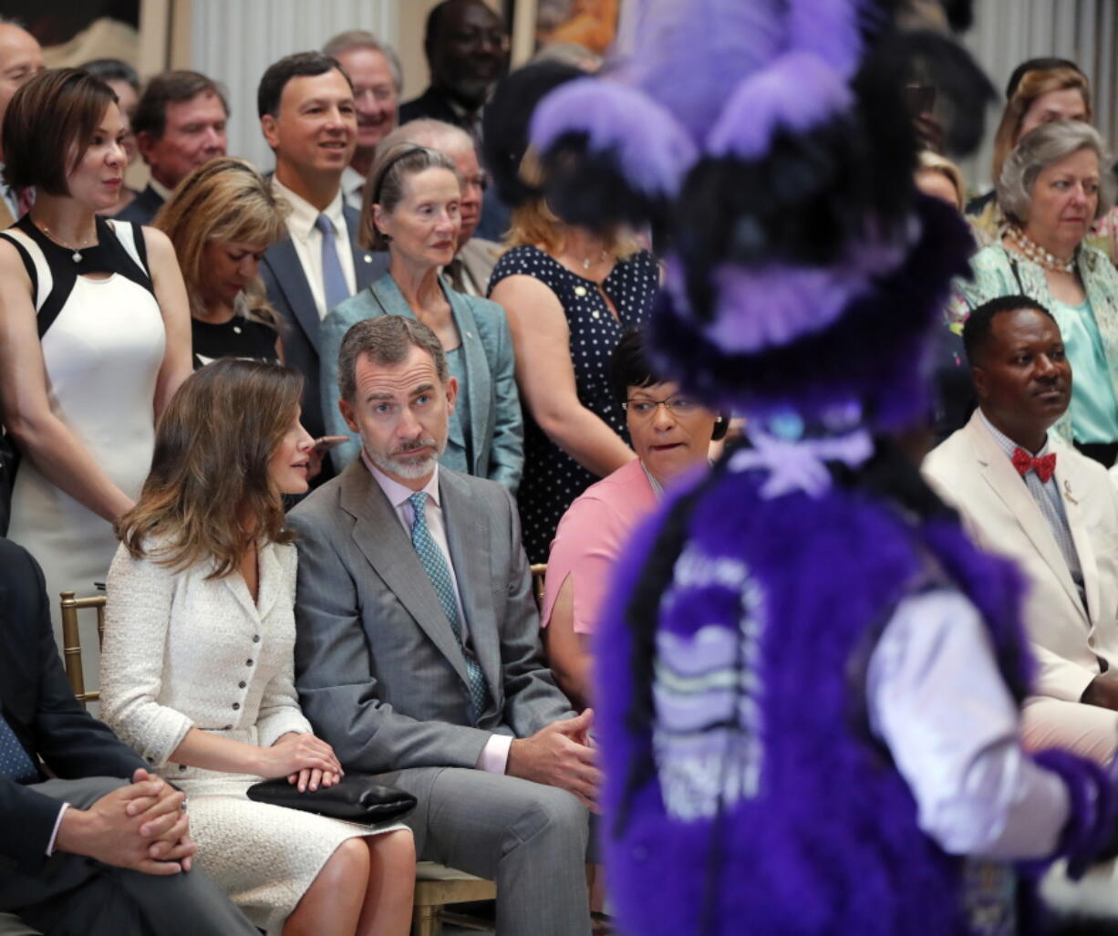 King Felipe VI and Queen Letizia of Spain watch Mardi Gras Indians perform Saturday at the New Orleans Museum of Art in New Orleans.