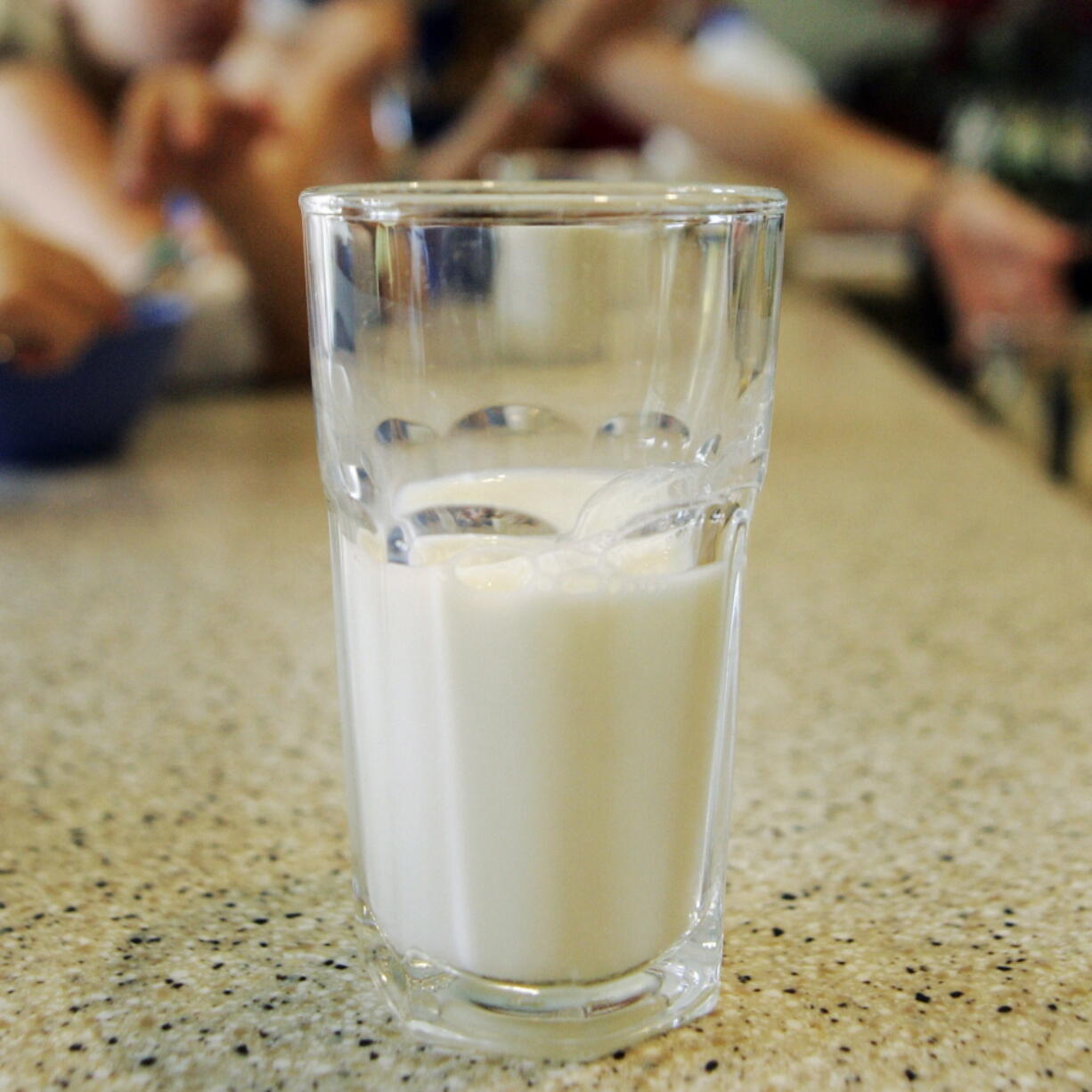 FILE - This June 8, 2007 file photo shows a glass of milk on a table during a family breakfast in Montgomery, Ala. Nearly 20 years ago, about nearly half of high school students said they drank at least one glass of milk a day. But now it’s down to less than a third, according to a survey released by the Centers for Disease Control and Prevention on Thursday, June 14, 2018.