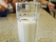 FILE - This June 8, 2007 file photo shows a glass of milk on a table during a family breakfast in Montgomery, Ala. Nearly 20 years ago, about nearly half of high school students said they drank at least one glass of milk a day. But now it’s down to less than a third, according to a survey released by the Centers for Disease Control and Prevention on Thursday, June 14, 2018.