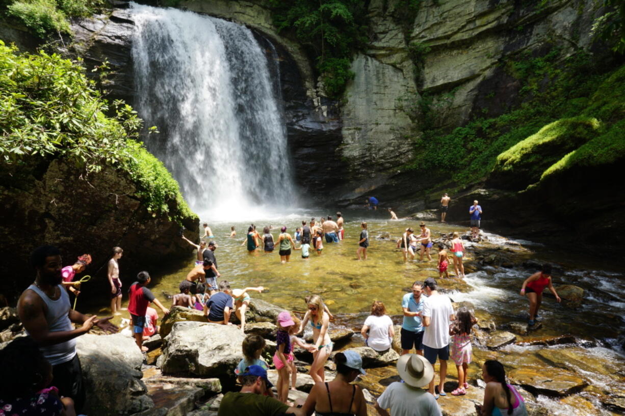 Swimmers wade in at the base of Looking Glass Falls in the Pisgah National Forest, between Brevard, N.C., and the Blue Ridge Parkway.