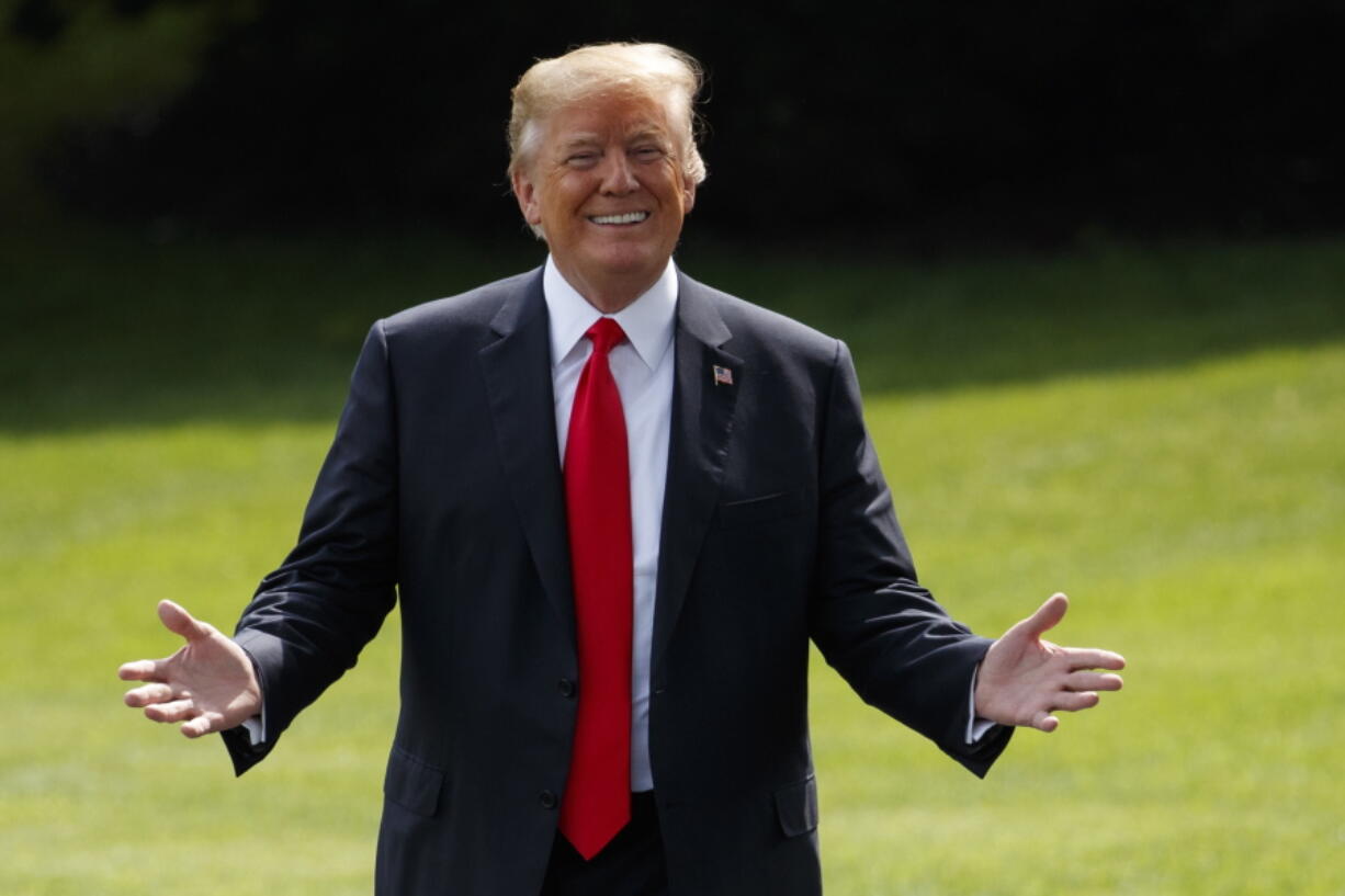 President Donald Trump gestures as reporters shout questions on his way to board Marine One on the South Lawn of the White House on Tuesday in Washington.