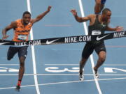 Noah Lyles beats Ronnie Baker, right, to the finish line while winning the men’s 100 meters the U.S. Championships athletics meet Friday, June 22, 2018, in Des Moines, Iowa.