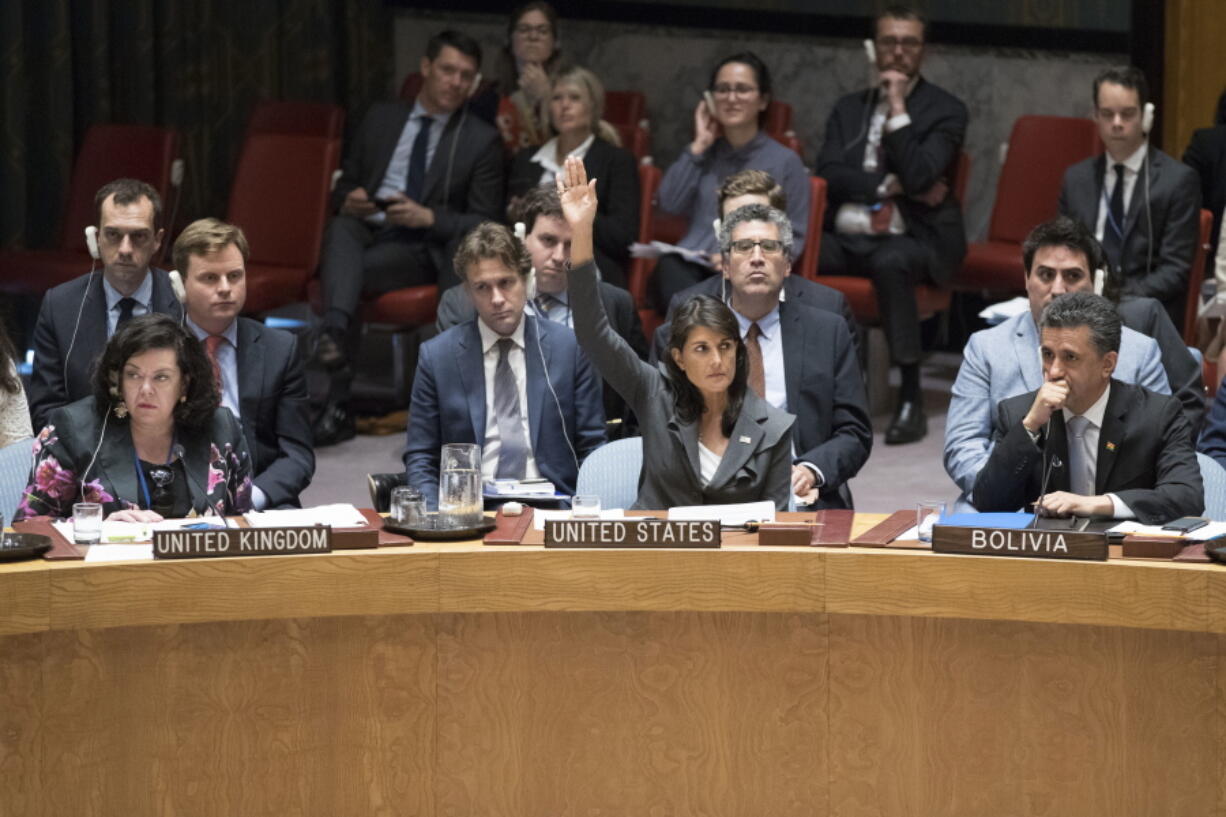 U.S. Ambassador to the United Nations Nikki Haley, center, votes in favor of a resolution introduced by the United States during a Security Council meeting on the situation between the Israelis and the Palestinians, Friday, June 1, 2018 at United Nations headquarters.