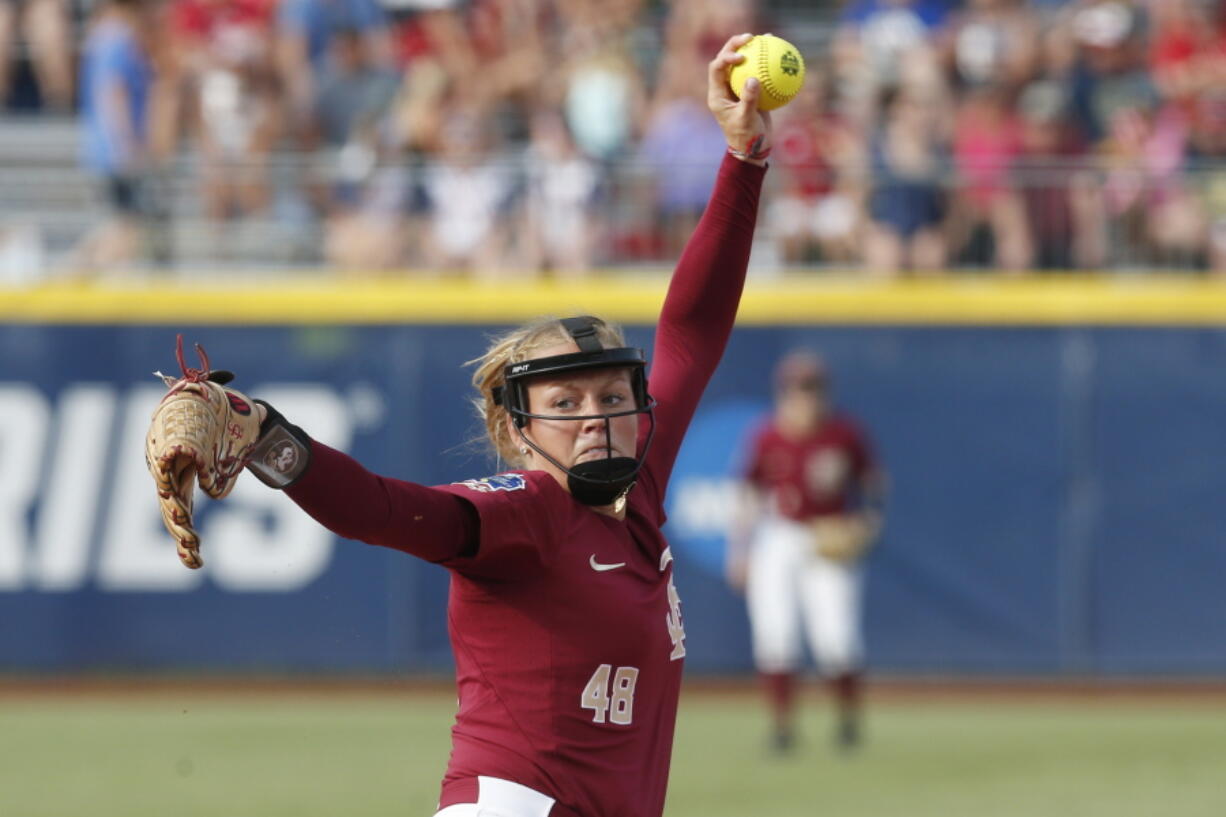 Florida State starting pitcher Meghan King throws in the first inning of the first softball game of the best-of-three championship series against Washington in the NCAA Women’s College World Series in Oklahoma City, Monday, June 4, 2018.