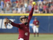 Florida State starting pitcher Meghan King throws in the first inning of the first softball game of the best-of-three championship series against Washington in the NCAA Women’s College World Series in Oklahoma City, Monday, June 4, 2018.