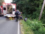 Emergency responders descended an embankment off Southeast Stiles Road in Washougal on Tuesday night to help an injured bicyclist who’d been struck by a car.