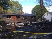 This house and car were destroyed by a fast-moving fire Thursday evening in Vancouver's Rose Village neighborhood.