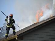 Clark County Fire District 6 and the Vancouver Fire Department work to put out a fire at 11906 N.E. 40th Ave. in Vancouver on Monday evening.