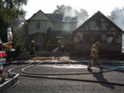 Clark County Fire District 6 and the Vancouver Fire Department work to put out a fire at 11906 NE 40th Avenue in Vancouver on Monday evening, July 30, 2018.