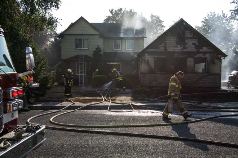 Clark County Fire District 6 and the Vancouver Fire Department work to put out a fire at 11906 NE 40th Avenue in Vancouver on Monday evening, July 30, 2018.