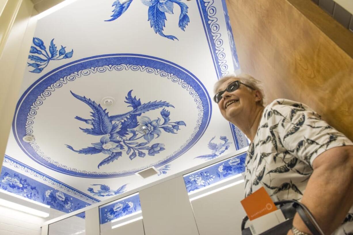 Gun-Marie Olsson, of Kristianstad, Sweden, calls for her husband to check out the ceiling of the women’s restroom at the Fort Vancouver Visitor Center on June 20.