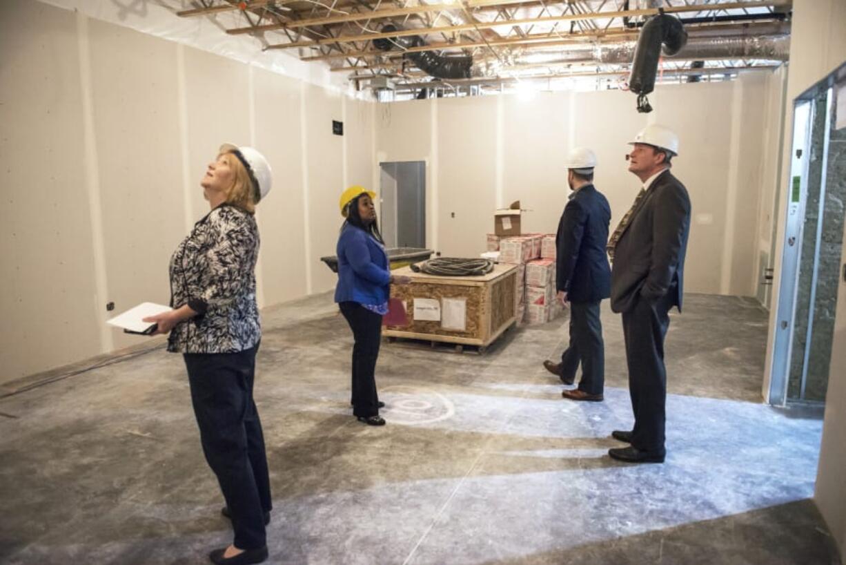 Vancouver Mayor Anne McEnerny-Ogle, from left, Bridgeview resource navigator Kelli Keyes, Bridgeview board member Tim Foley and Bridgeview board member Craig Pridemore tour the Bridgeview Education and Employment Resource Center on Thursday. The facility will open in the fall and help connect low-income people to services.