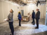 Vancouver Mayor Anne McEnerny-Ogle, from left, Bridgeview resource navigator Kelli Keyes, Bridgeview board member Tim Foley and Bridgeview board member Craig Pridemore tour the Bridgeview Education and Employment Resource Center on Thursday. The facility will open in the fall and help connect low-income people to services.