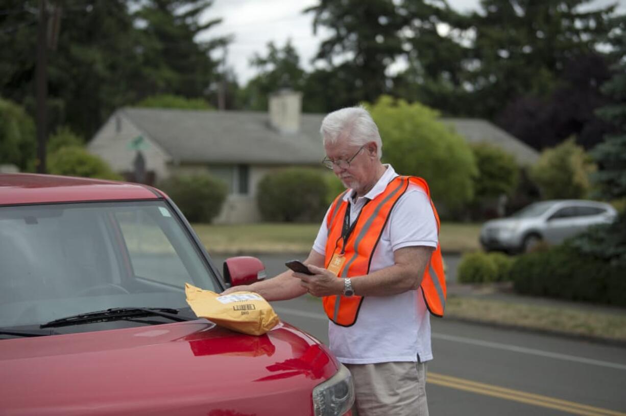 Daniel Jensen, an Amazon Flex independent contractor, prepares to deliver a package for a customer in Vancouver on Thursday morning. Jensen enjoys gig work and being able to shut it off when he likes so that he can travel and spend time with his wife.