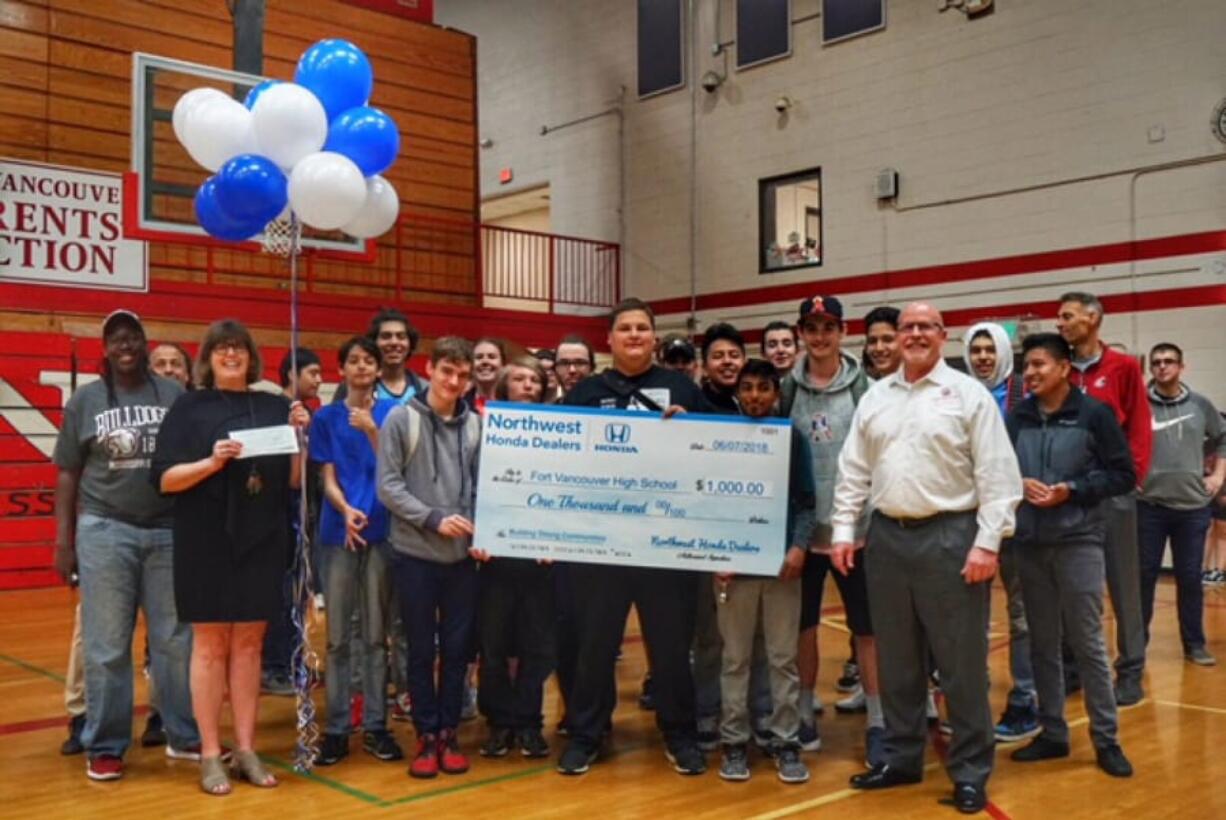 Meadow Homes: Students and staffers at Fort Vancouver High School celebrating their $1,000 check from Northwest Honda Dealers.