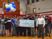 Meadow Homes: Students and staffers at Fort Vancouver High School celebrating their $1,000 check from Northwest Honda Dealers.