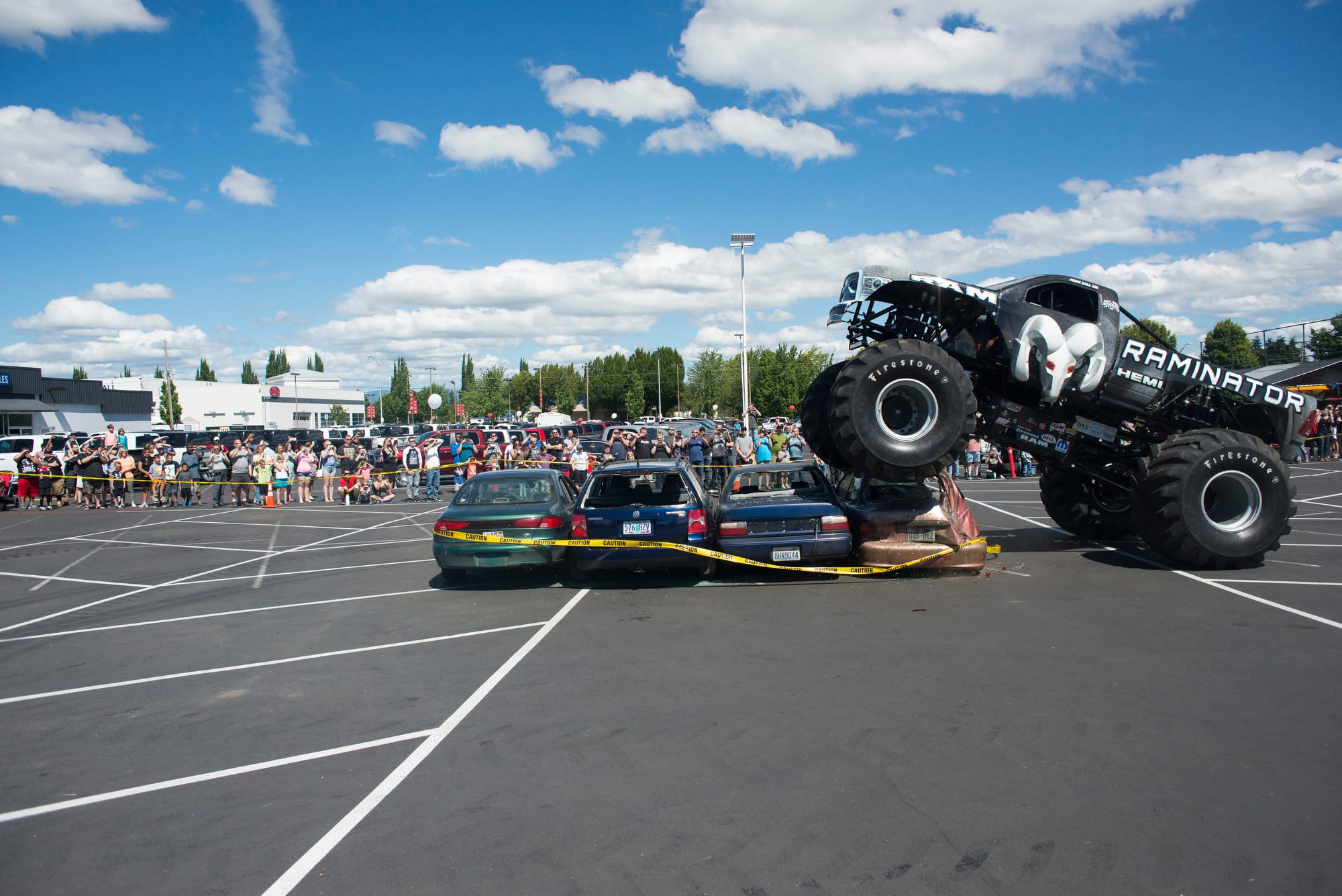 The Raminator, driven by Kurt Kraehmer, drives over a line of cars at the Dick Hannah Truck Center in Vancouver on Sunday, July 1, 2018. The Raminator is on a tour of Dodge dealerships.