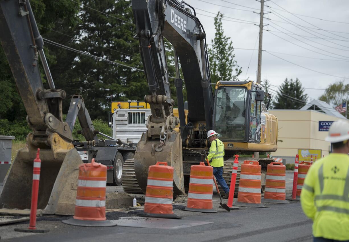 Workers from NW Natural respond after an excavator damaged a natural gas line on Northeast 78th Street in Hazel Dell causing a road closure Monday morning, July 2, 2018. No injuries were reported in the incident and traffic was routed around the scene.