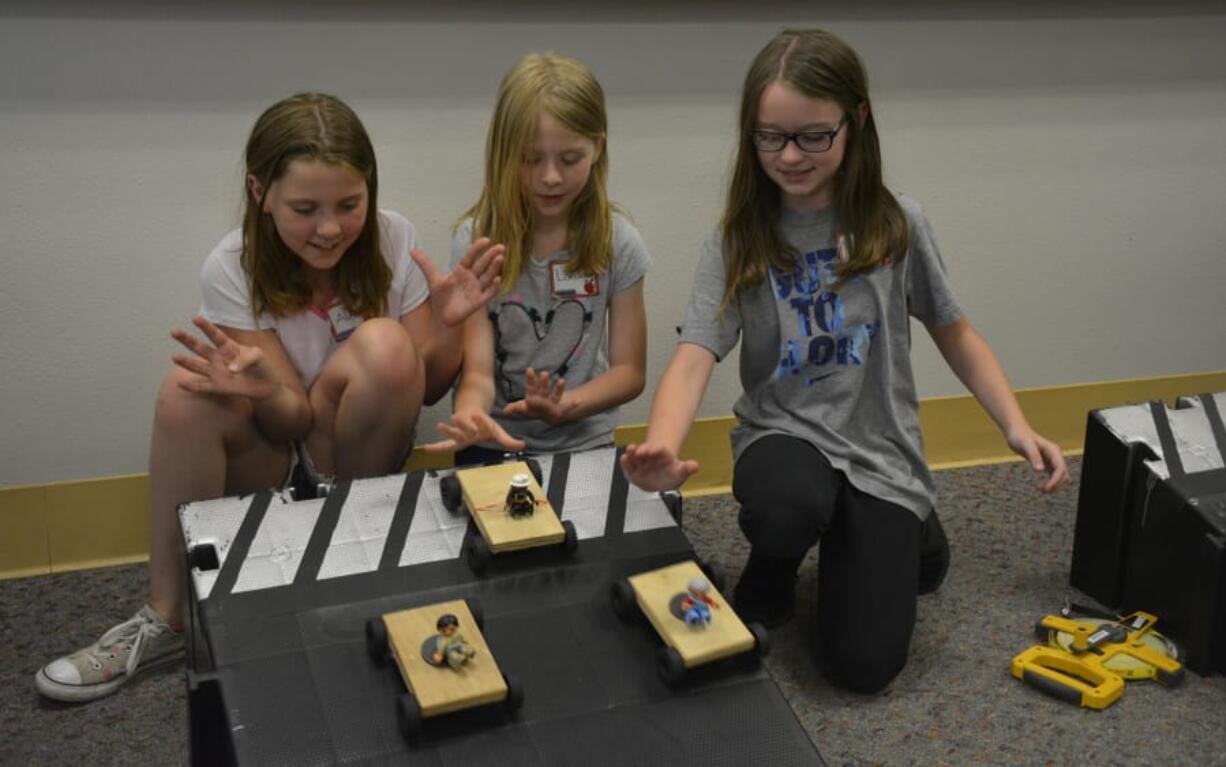 Washougal: Hathaway Elementary School third-graders, from left, Alexis Wright, London Hickey and Violet Cole at a workshop hosted by the Oregon Museum of Science and Industry where girls were asked to design and test a car.