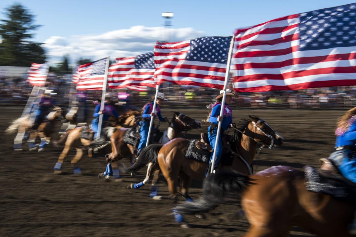 The drill team presents the colors during the 48th annual Vancouver Rodeo on Friday at the Clark County Saddle Club. The rodeo continues Saturday night. Gates will open at 5 p.m., and the main competitions begin at 7 p.m.