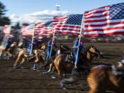 The drill team presents the colors during the 48th annual Vancouver Rodeo on Friday at the Clark County Saddle Club. The rodeo continues Saturday night. Gates will open at 5 p.m., and the main competitions begin at 7 p.m.