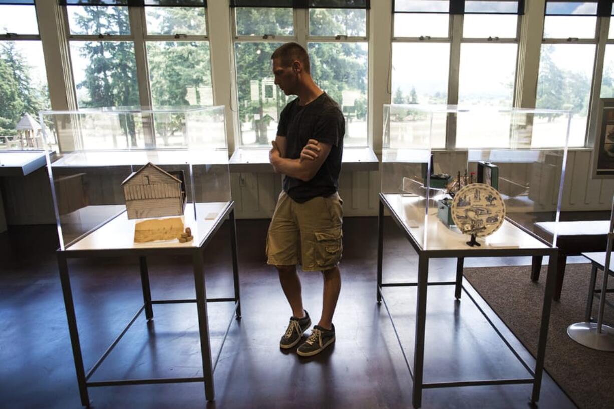 Andy Trapani of San Jose, Calif., views the Na Kanaka art installation Friday afternoon at the Fort Vancouver Visitor Center.