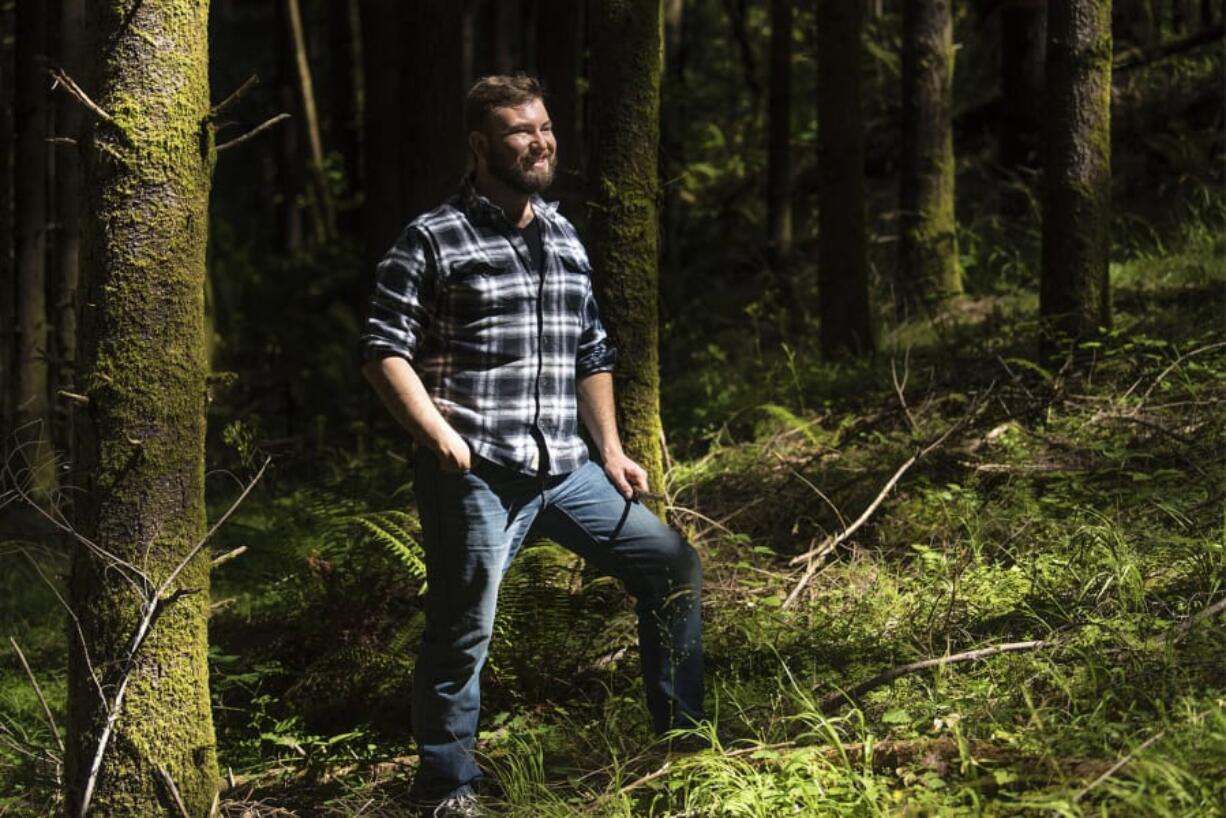 Hunter Decker, a forester with Clark County Public Works, poses for a press photo at Camp Bonneville. He spends some days out at Camp Bonneville and others working with the public and permitting issues.