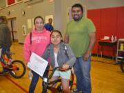 Washougal: Hathaway Elementary School fourth-grader Abigail Picho with parents Graciela and Facundo Picho, and a new bicycle she won through the school’s Strive for Five attendance program.