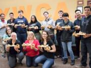 Orchards: Susan Mangin’s Imagine It, Design It, Make It class at Heritage High School, and some of the wood cars and trucks they made, about half of which were donated to YWCA Clark County’s Safechoice program for children affected by domestic violence.
