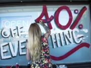 Jessie Leonetti, a budtender at Sticky’s Pot Shop, paints a sale announcement on the store’s window. The Hazel Dell pot shop will close soon after the state Supreme Court declined to hear their appeal to lift the ban on recreational marijuana sales in unincorporated Clark County.