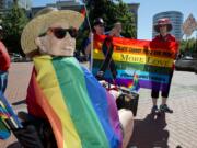 “Lesbian visibility” is the point of the annual Dyke March that’s part of Saturday in the Park Pride, according to organizer Simona Matteucci, who steered a motorized wheelchair and held up a sign reading “Italian lesbians: deal with it.” (James Rexroad for the Columbian)